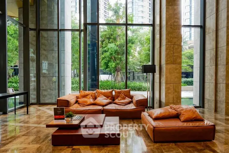 Luxurious modern living room with floor-to-ceiling windows and elegant leather furniture.