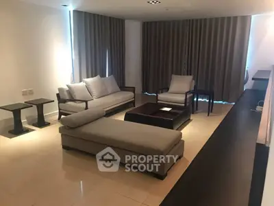 Spacious modern living room with elegant furniture and natural lighting.