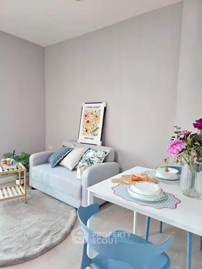 Charming living room with cozy sofa and dining area, perfect for modern living.