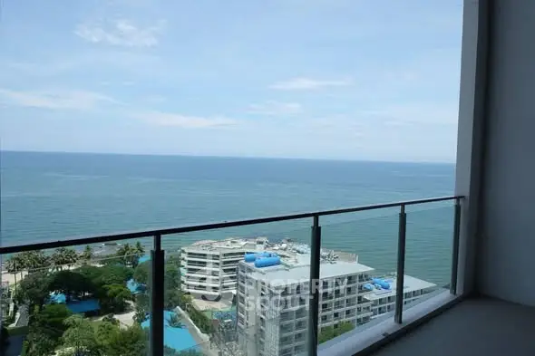 Stunning ocean view from high-rise balcony overlooking serene blue waters.