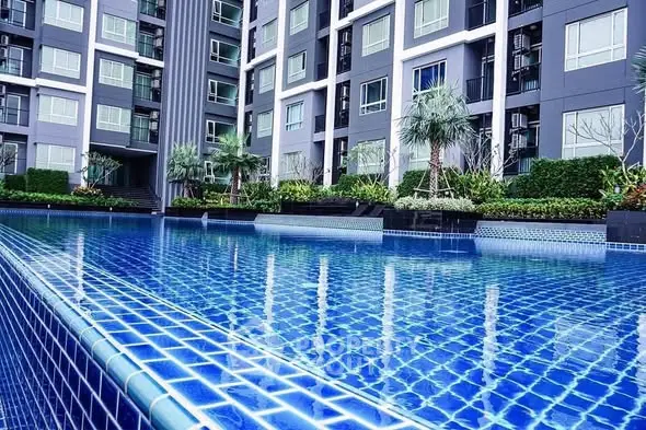 Luxurious modern apartment complex with stunning pool and lush greenery