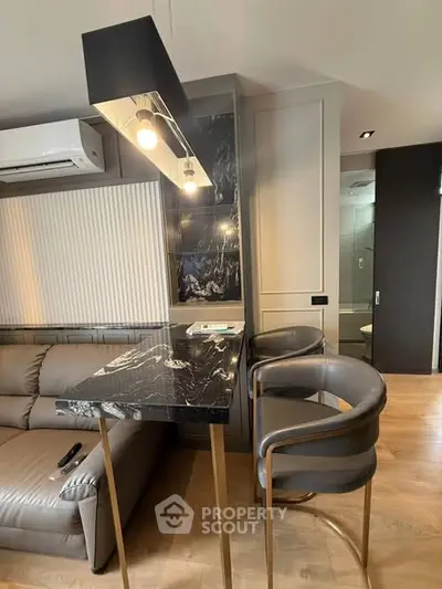 Modern living room with sleek marble table and stylish lighting