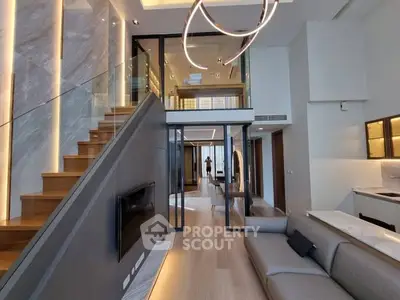 Luxurious modern living room with elegant staircase and stylish lighting