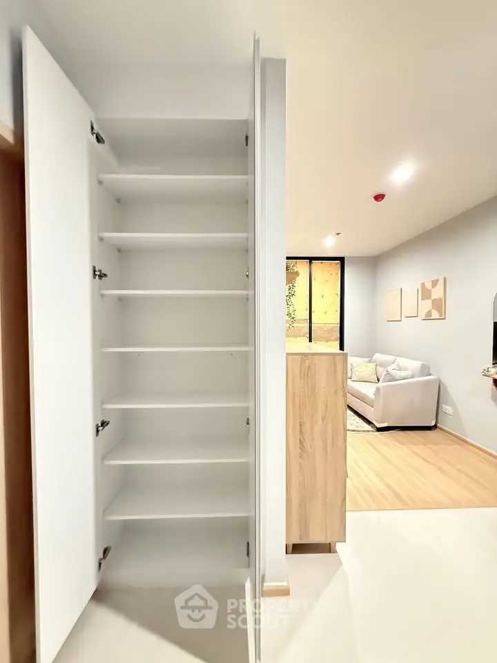 Modern apartment interior with open storage and cozy living room