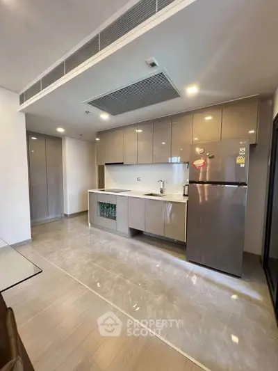 Modern kitchen with sleek cabinets and stainless steel appliances in a spacious open layout.