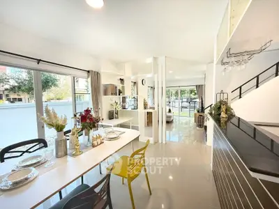 Modern open-plan kitchen and dining area with sleek design and ample natural light.