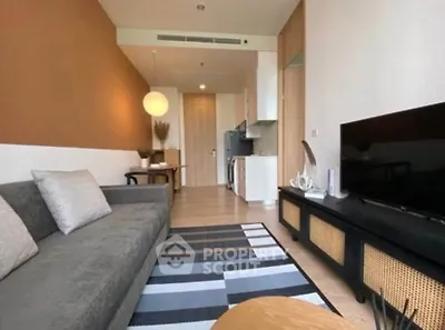 Modern living room with stylish decor and open kitchen layout in a cozy apartment.