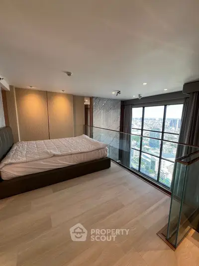 Luxurious bedroom with stunning city view and modern design in high-rise apartment.