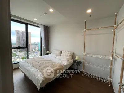 Modern bedroom with city view and minimalist decor in high-rise apartment
