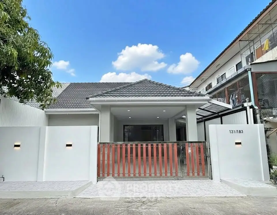 Charming single-story home with modern facade and gated entrance