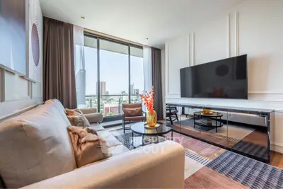 Luxurious living room with modern decor and stunning city view from large windows.
