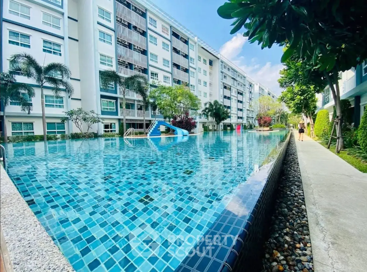Luxurious condominium with stunning pool and lush greenery, perfect for relaxation and modern living.