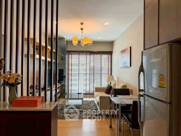 Modern living room with open layout, stylish decor, and natural light from large windows.