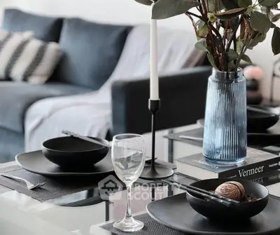 Stylish modern living room with elegant dining setup and cozy sofa.