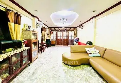 Spacious living room with elegant decor and unique ceiling design
