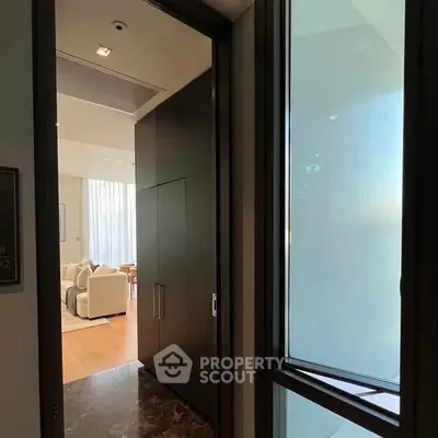 Modern apartment entrance with view into stylish living room