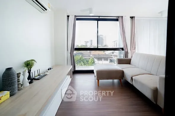 Modern living room with large window and stylish decor