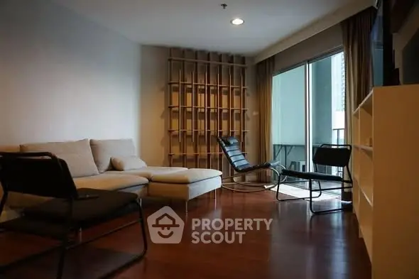 Spacious living room with modern furniture and large windows for natural light.
