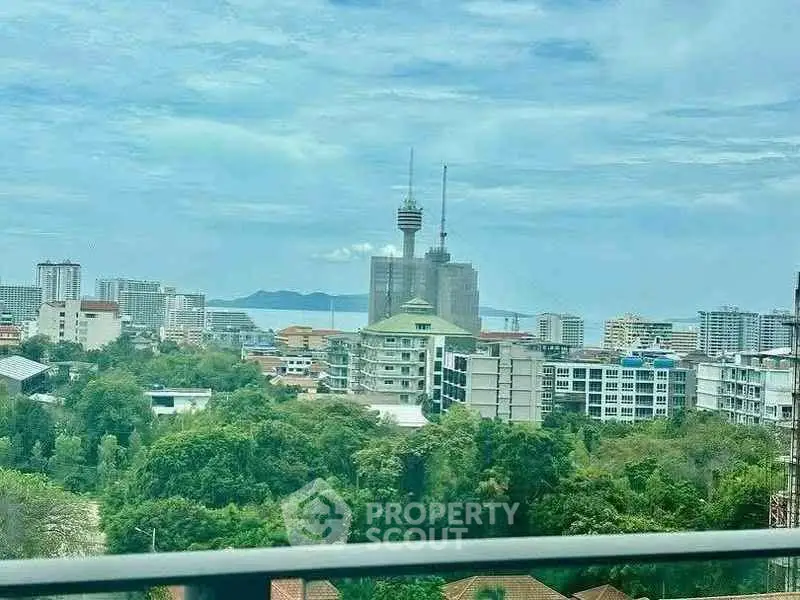 Stunning cityscape view with lush greenery and iconic tower, perfect for urban living enthusiasts.