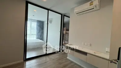 Modern bedroom with glass partition and air conditioning in stylish apartment