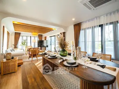 Luxurious open-plan living and dining area with elegant decor and abundant natural light.