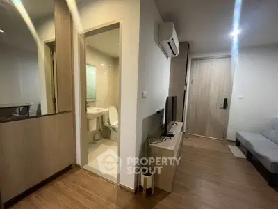 Modern apartment interior with wooden flooring and compact bathroom