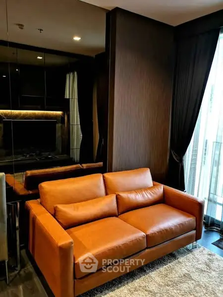 Luxurious living room with elegant brown leather sofa and floor-to-ceiling windows.
