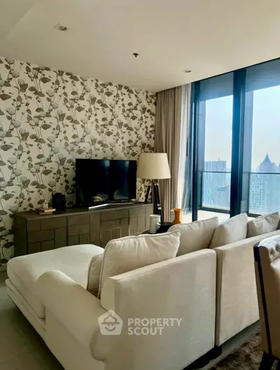 Stylish living room with floral wallpaper and city view, featuring a cozy sofa and modern decor.
