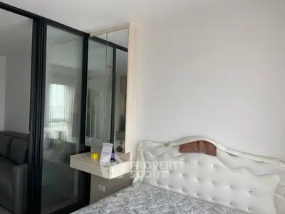 Modern bedroom with elegant bed and mirrored closet in stylish apartment.