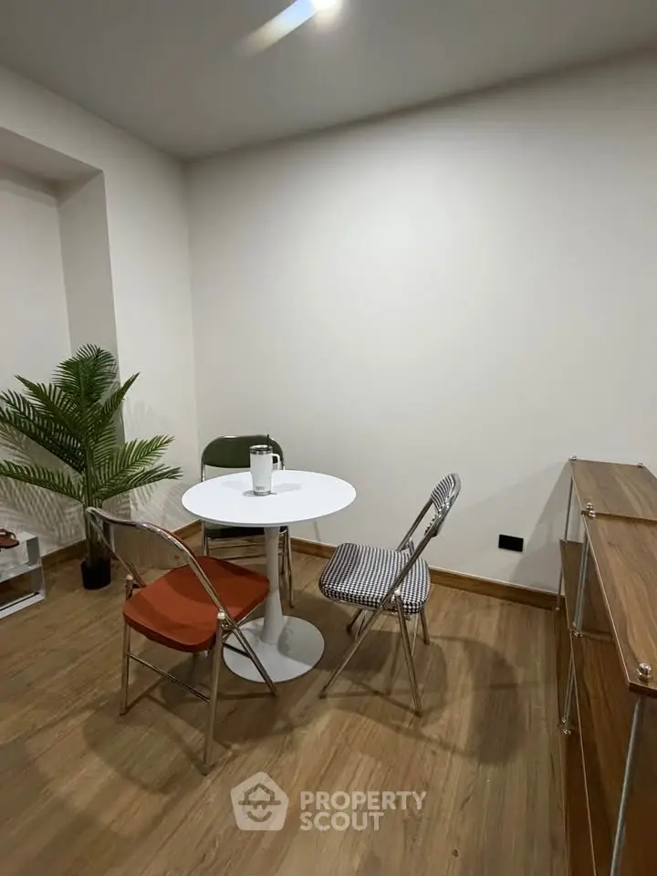 Cozy dining area with modern chairs and wooden flooring, perfect for intimate gatherings.