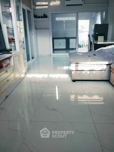 Spacious living room with modern decor and large windows for natural light.