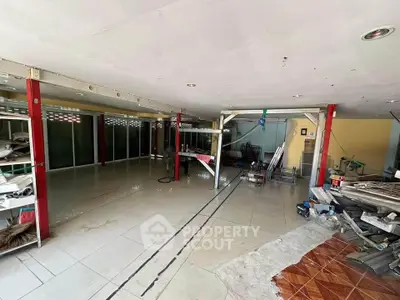 Spacious commercial space with tiled flooring and large windows, ideal for retail or office setup.