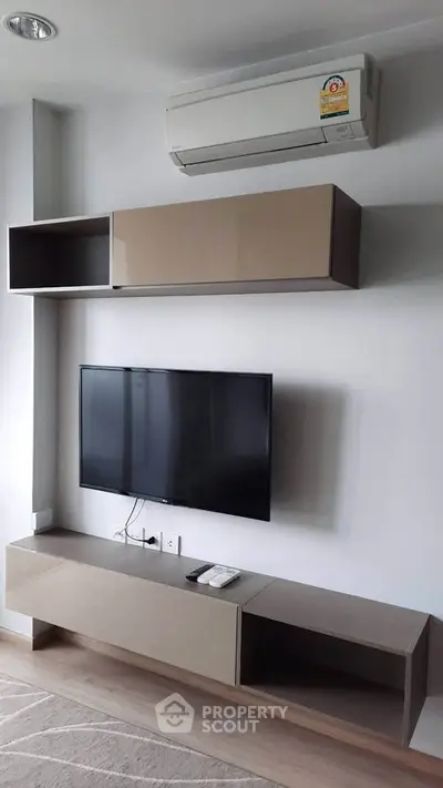 Modern living room with sleek TV unit and air conditioning