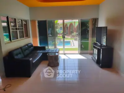 Spacious living room with pool view and modern furniture