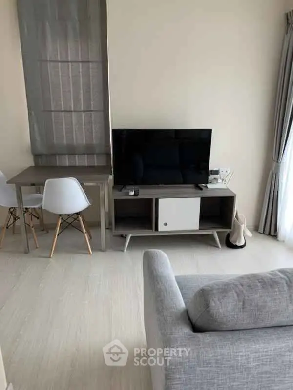 Modern living room with sleek furniture and natural light, perfect for relaxation and entertainment.