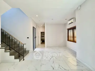 Spacious modern interior with marble flooring and staircase, perfect for stylish living.