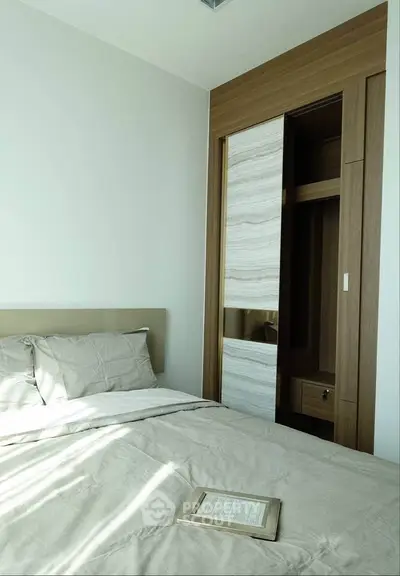 Modern bedroom with built-in closet and natural light