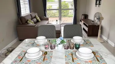 Charming living room with elegant dining setup and cozy seating area, perfect for entertaining.