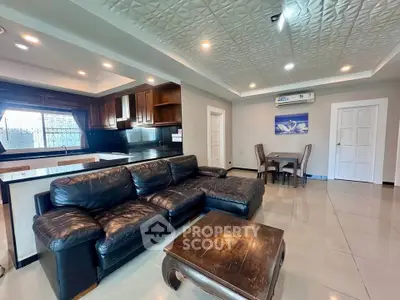 Spacious living room with modern open kitchen and elegant ceiling design