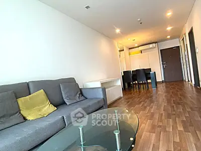 Spacious modern living room with wooden flooring and stylish furniture