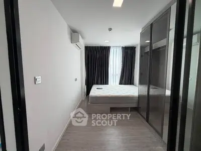 Modern bedroom with sleek design and large mirrored wardrobe