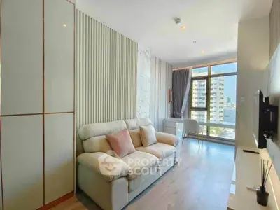 Modern living room with cozy sofa and large window offering city view