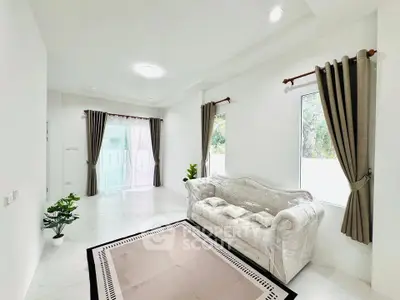 Spacious living room with elegant sofa and large windows for natural light