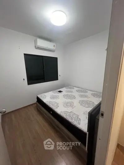 Modern bedroom with stylish decor and wooden flooring