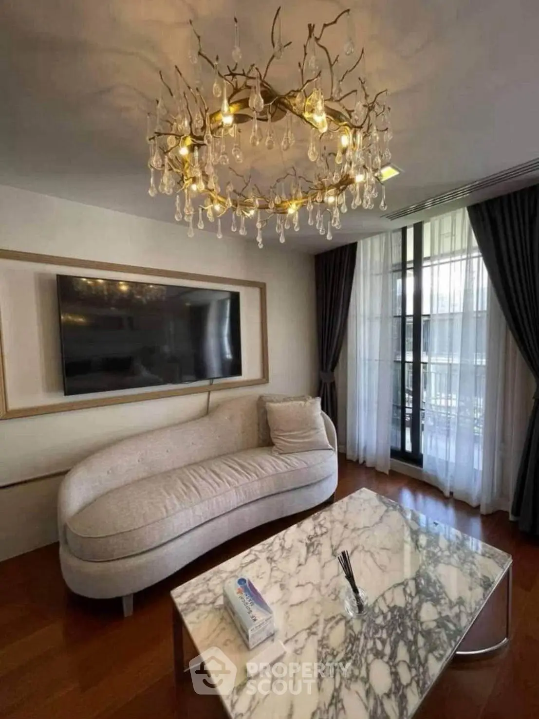 Luxurious living room with elegant chandelier and marble coffee table