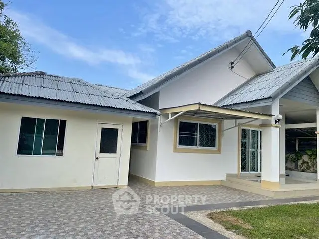 Charming single-story home with spacious driveway and modern exterior design.