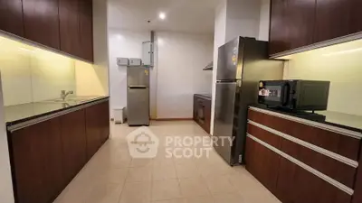 Spacious modern kitchen with sleek cabinetry and stainless steel appliances.