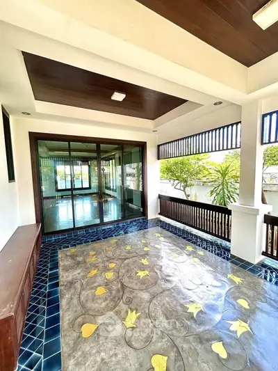 Spacious balcony with decorative flooring and garden view