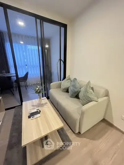 Modern living room with cozy sofa and stylish decor in a contemporary apartment.