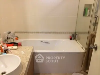 Modern bathroom with bathtub and elegant fixtures in a stylish apartment.